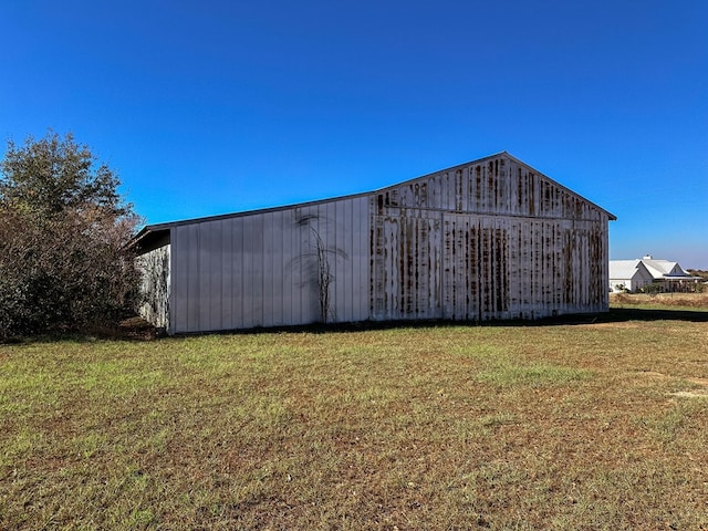 view of outbuilding featuring a lawn