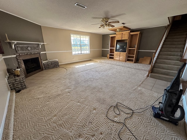 unfurnished living room featuring ceiling fan, light carpet, and a textured ceiling