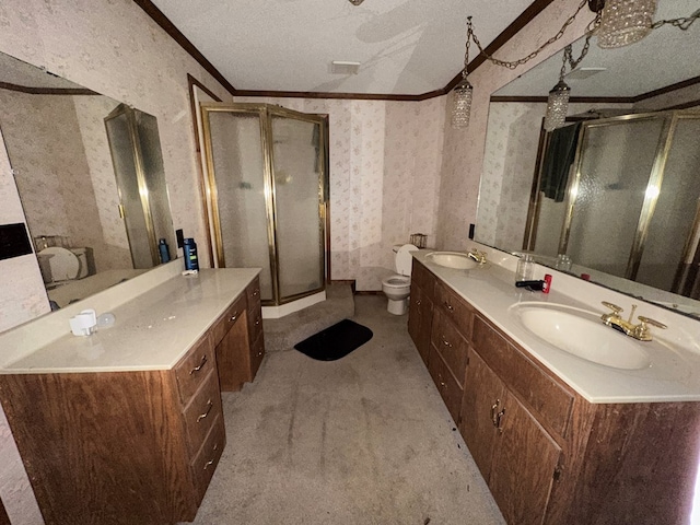 bathroom with vanity, a textured ceiling, a shower with door, crown molding, and toilet