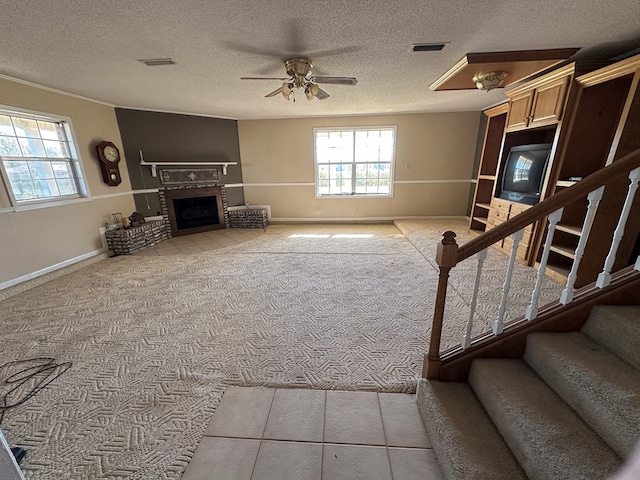 carpeted living room with ceiling fan and a textured ceiling