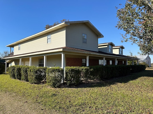 view of side of home featuring a yard