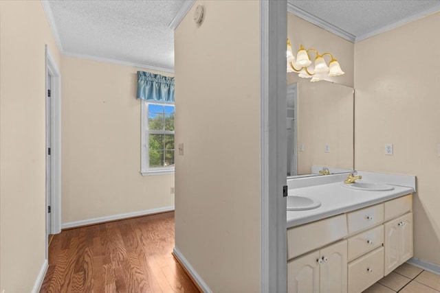 105 Christen Ln, Dothan, AL 36305 - bathroom featuring crown molding, a sink, wood finished floors, a textured ceiling, and double vanity
