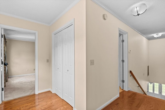 105 Christen Ln, Dothan, AL 36305 - hallway featuring a textured ceiling, an upstairs landing, light wood-style flooring, and ornamental molding
