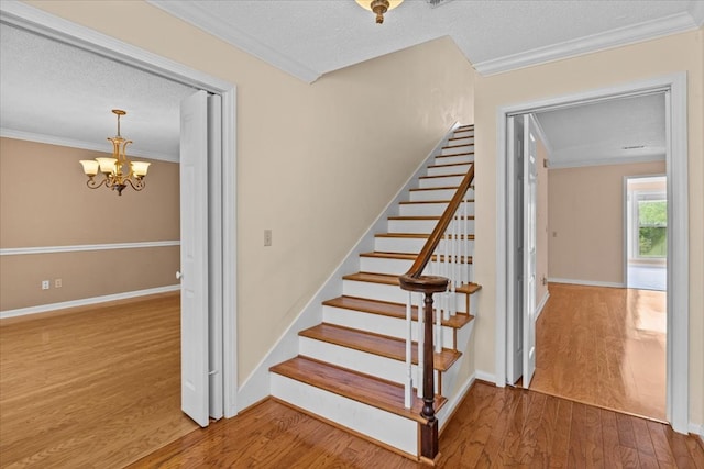 105 Christen Ln, Dothan, AL 36305 - stairway with a textured ceiling, ornamental molding, wood finished floors, and an inviting chandelier