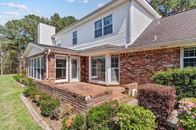 105 Christen Ln, Dothan, AL 36305 - back of house with a chimney, brick siding, a yard, and a patio area