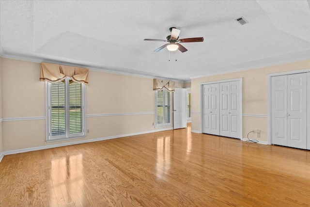 105 Christen Ln, Dothan, AL 36305 - interior space with multiple closets, a textured ceiling, a raised ceiling, visible vents, and wood finished floors