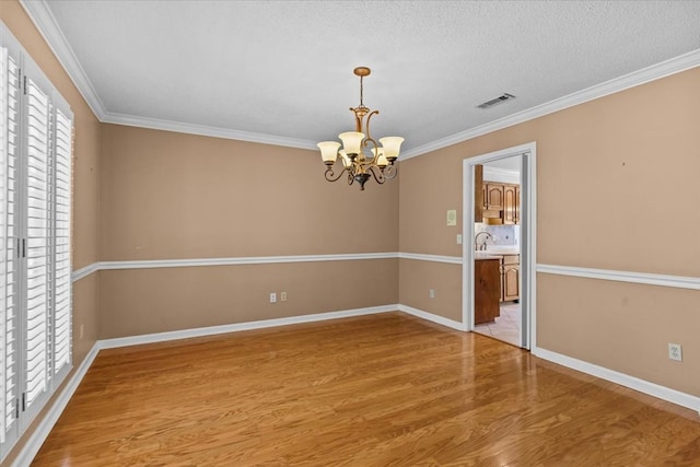 105 Christen Ln, Dothan, AL 36305 - spare room featuring a wealth of natural light, visible vents, a notable chandelier, and wood finished floors