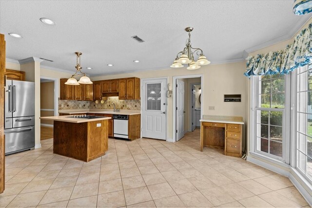 105 Christen Ln, Dothan, AL 36305 - kitchen with light countertops, a chandelier, tasteful backsplash, high end refrigerator, and dishwasher