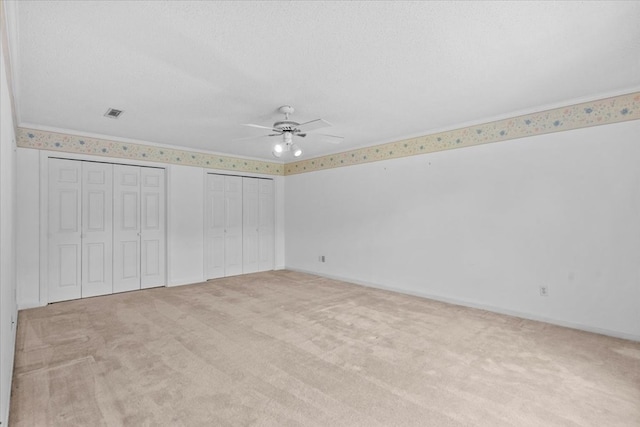 105 Christen Ln, Dothan, AL 36305 - unfurnished bedroom featuring light colored carpet, two closets, and a textured ceiling