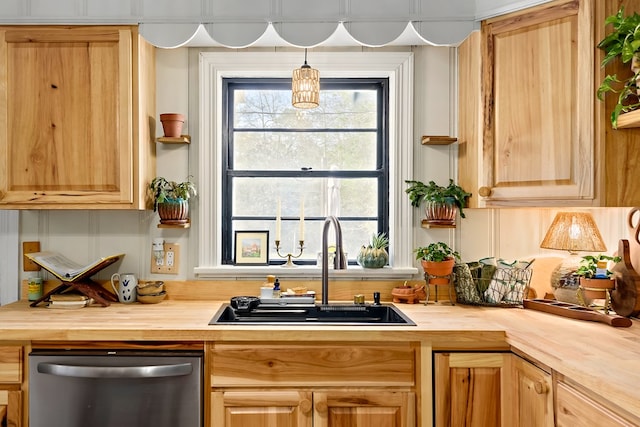 kitchen featuring a sink, wooden counters, stainless steel dishwasher, and light brown cabinetry