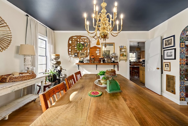 dining area featuring ornamental molding, visible vents, plenty of natural light, and wood finished floors