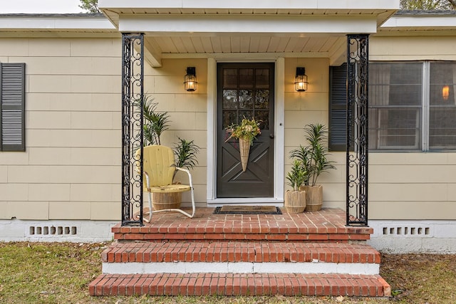 property entrance featuring covered porch and crawl space