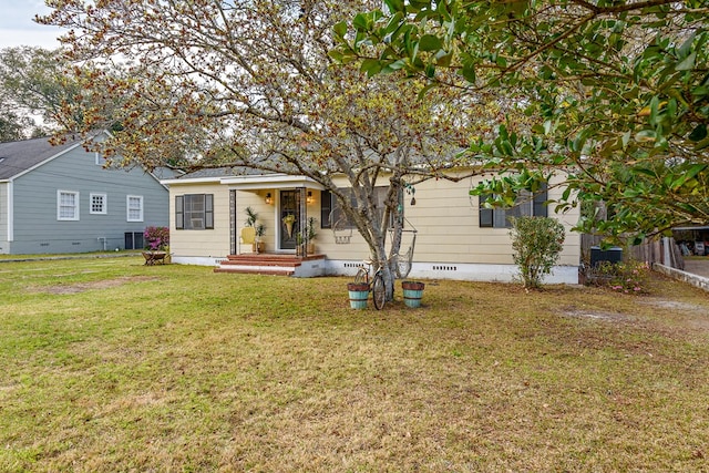 rear view of house with crawl space and a yard