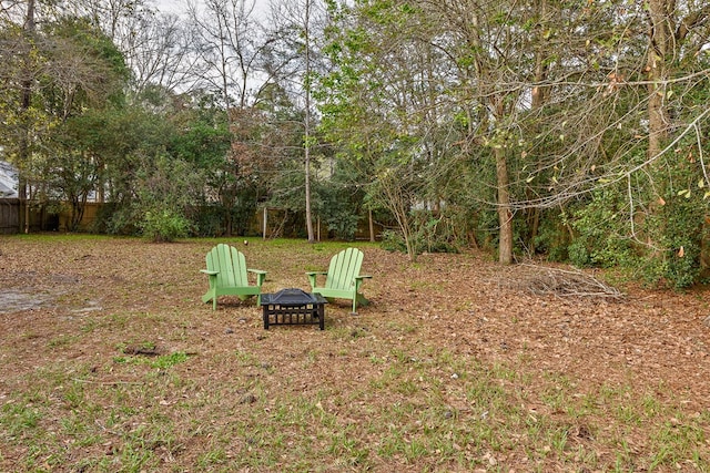 view of yard featuring a fire pit and fence