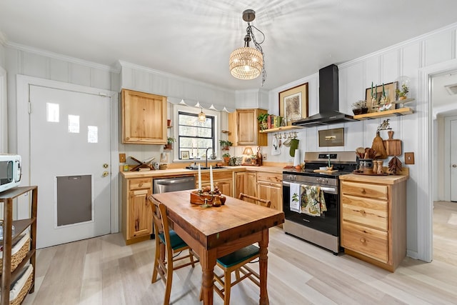 kitchen with open shelves, appliances with stainless steel finishes, ornamental molding, a sink, and wall chimney range hood