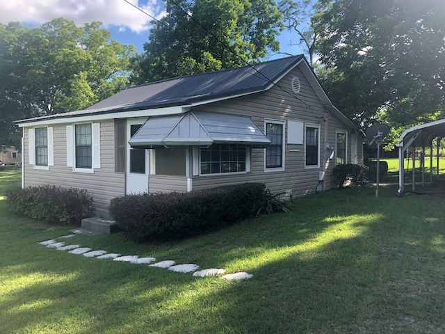 view of home's exterior featuring a yard and a carport