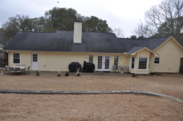 back of property featuring a patio area and french doors