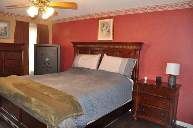 bedroom featuring dark hardwood / wood-style flooring and ceiling fan