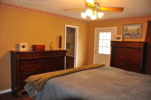 bedroom featuring ceiling fan and ensuite bath