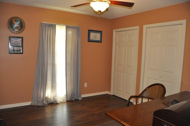 office area featuring dark wood-type flooring and ceiling fan