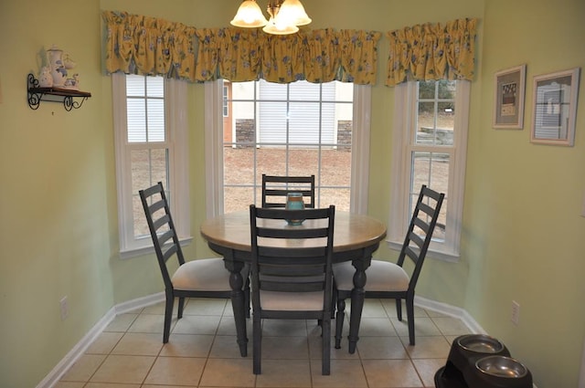 dining space featuring light tile patterned floors and an inviting chandelier