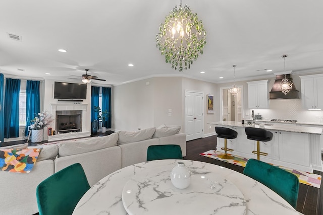114 Bozeman Way, Dothan, AL 36305 - dining space featuring recessed lighting, a chandelier, a ceiling fan, dark wood-style floors, and a fireplace