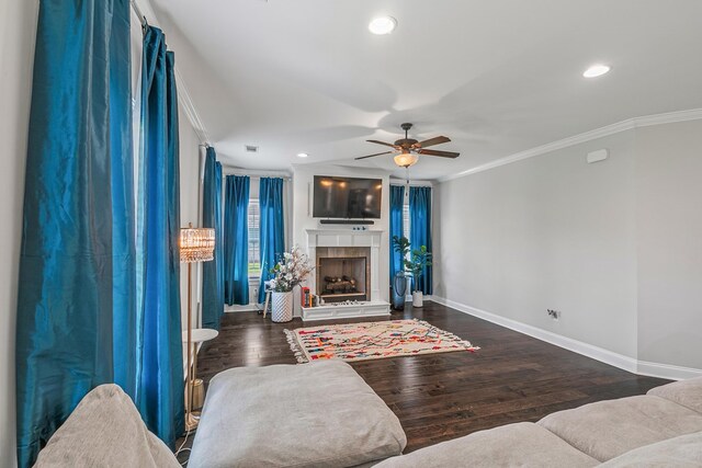 114 Bozeman Way, Dothan, AL 36305 - living area with crown molding, baseboards, ceiling fan, a tile fireplace, and wood finished floors