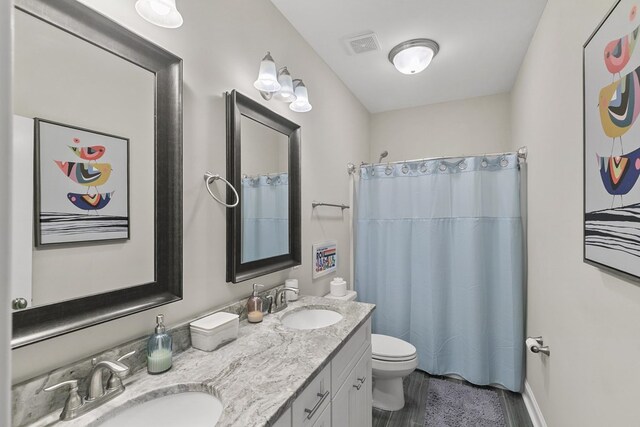 114 Bozeman Way, Dothan, AL 36305 - bathroom featuring toilet, double vanity, and a shower with shower curtain