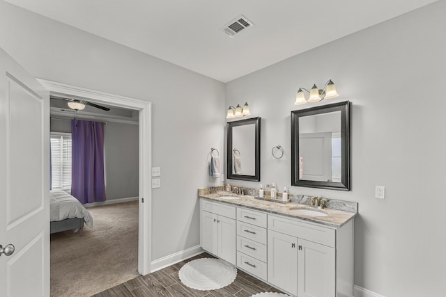 114 Bozeman Way, Dothan, AL 36305 - bathroom featuring double vanity, baseboards, wood finished floors, and ensuite bath