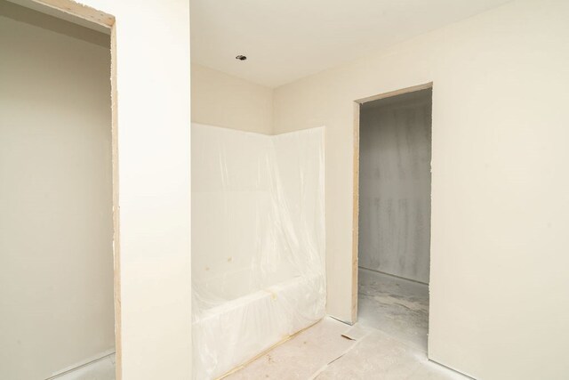 full bath featuring unfinished concrete floors