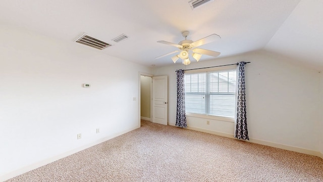 carpeted spare room with vaulted ceiling and ceiling fan