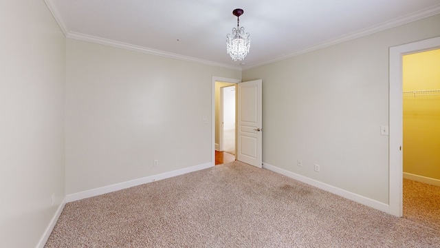 unfurnished bedroom with crown molding, a walk in closet, carpet flooring, and a notable chandelier