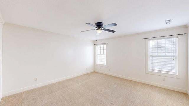 carpeted spare room with ornamental molding and ceiling fan