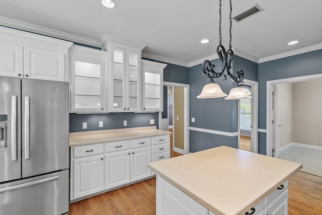 109 Glencoe Way, Dothan, AL 36305 - kitchen featuring stainless steel refrigerator with ice dispenser, light countertops, glass insert cabinets, white cabinets, and recessed lighting
