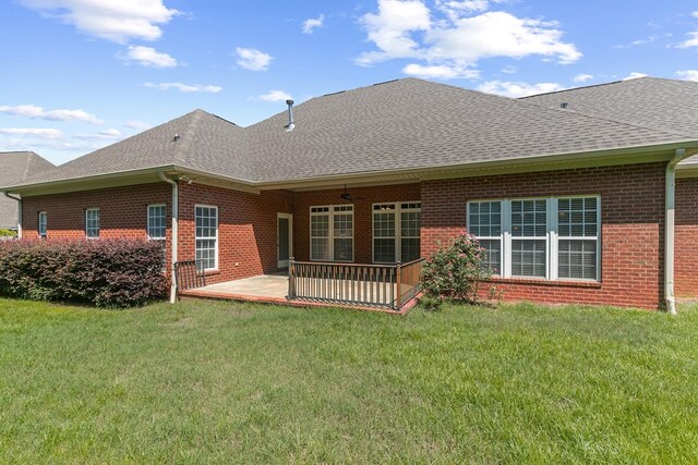 109 Glencoe Way, Dothan, AL 36305 - back of house featuring a shingled roof, brick siding, a patio, and a lawn