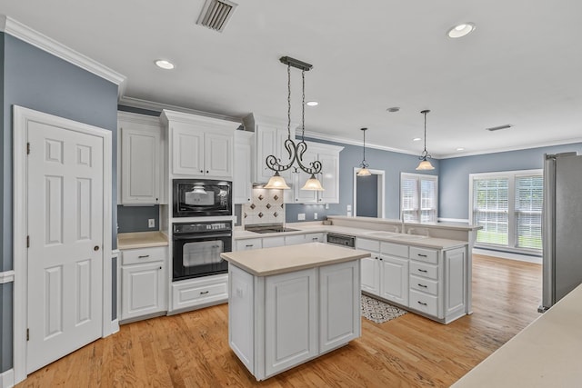 109 Glencoe Way, Dothan, AL 36305 - kitchen with black appliances, light wood-style floors, light countertops, white cabinetry, and recessed lighting