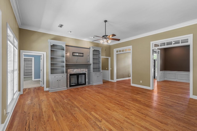 109 Glencoe Way, Dothan, AL 36305 - unfurnished living room with ceiling fan, a stone fireplace, light wood-style floors, and crown molding