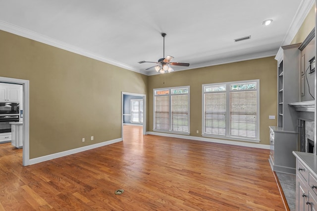 109 Glencoe Way, Dothan, AL 36305 - unfurnished living room featuring a ceiling fan, crown molding, light wood-style floors, a premium fireplace, and recessed lighting