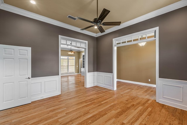 109 Glencoe Way, Dothan, AL 36305 - unfurnished room featuring ceiling fan, light wood-style floors, crown molding, wainscoting, and a decorative wall