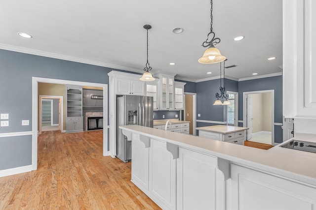 109 Glencoe Way, Dothan, AL 36305 - kitchen featuring stainless steel fridge, crown molding, a kitchen island, glass insert cabinets, and white cabinets