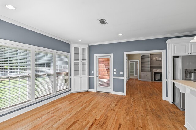 109 Glencoe Way, Dothan, AL 36305 - unfurnished living room with ornamental molding, light wood-style flooring, recessed lighting, a fireplace, and built in shelves