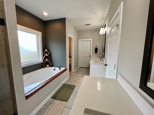 212 Neenan Dr, Enterprise, AL 36330 - bathroom with marble look tile flooring, a bath, vanity, and recessed lighting