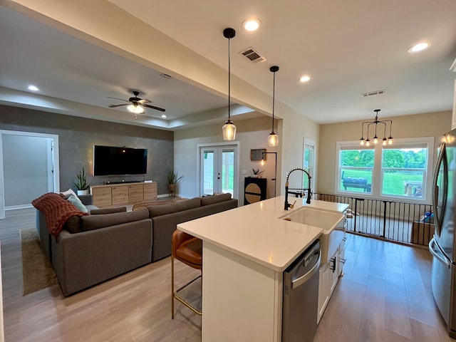 212 Neenan Dr, Enterprise, AL 36330 - kitchen with stainless steel appliances, a sink, light wood-style floors, white cabinets, and recessed lighting