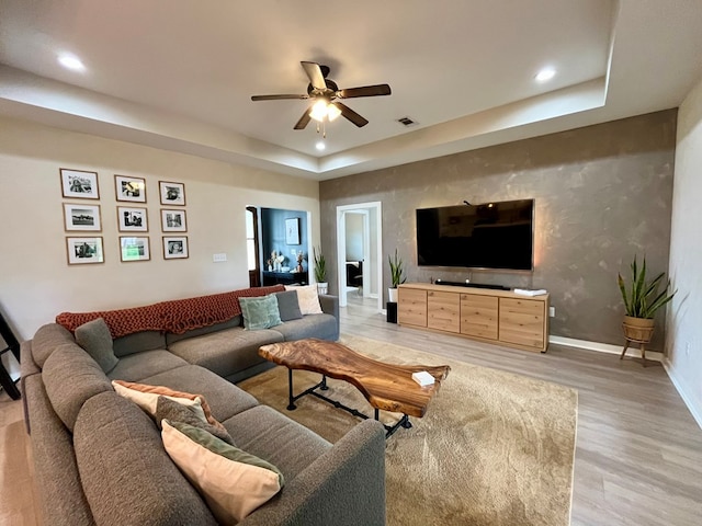 212 Neenan Dr, Enterprise, AL 36330 - living room with ceiling fan, light wood finished floors, a tray ceiling, baseboards, and recessed lighting