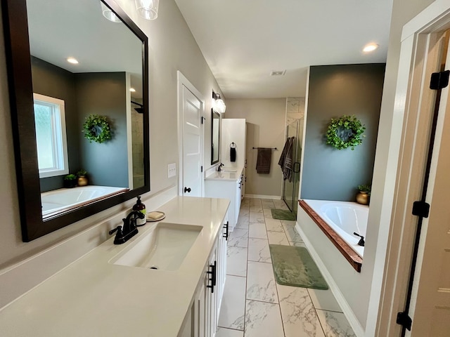 212 Neenan Dr, Enterprise, AL 36330 - full bath featuring marble finish flooring, a stall shower, a bath, vanity, and baseboards