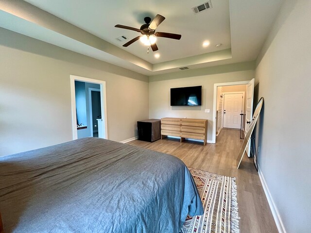 212 Neenan Dr, Enterprise, AL 36330 - bedroom featuring baseboards, light wood-type flooring, a raised ceiling, recessed lighting, and ceiling fan