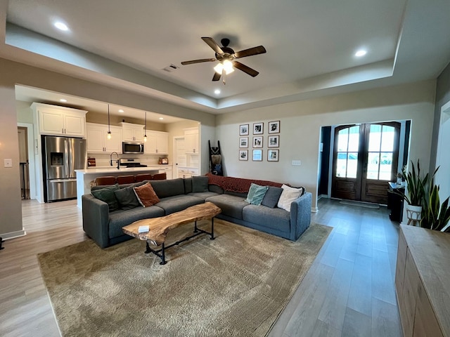 212 Neenan Dr, Enterprise, AL 36330 - living room featuring a tray ceiling, recessed lighting, ceiling fan, light wood-type flooring, and baseboards