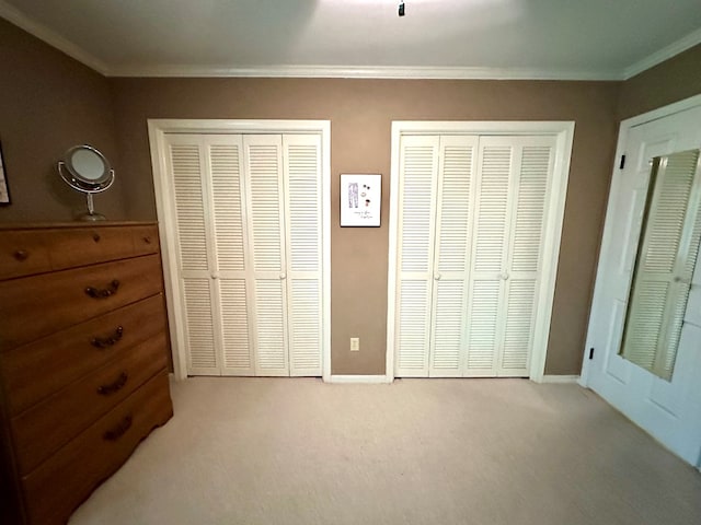 1317 Cambridge Rd, Dothan, AL 36305 - unfurnished bedroom with two closets, carpet, crown molding, and baseboards