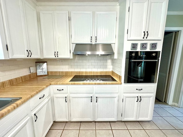 1317 Cambridge Rd, Dothan, AL 36305 - kitchen featuring black appliances, under cabinet range hood, light tile patterned flooring, and white cabinets
