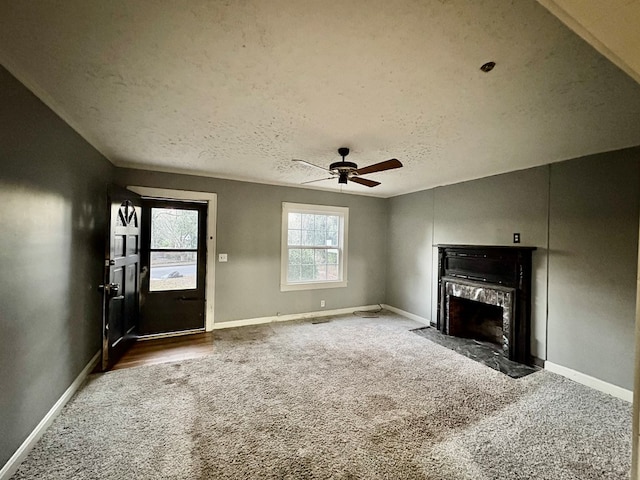 unfurnished living room featuring a textured ceiling, carpet floors, and ceiling fan